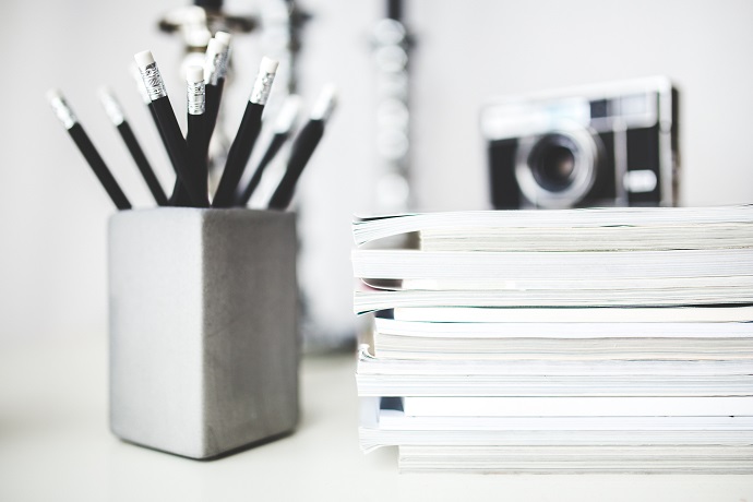 Career ideas. Camera sitting on a pile of books.