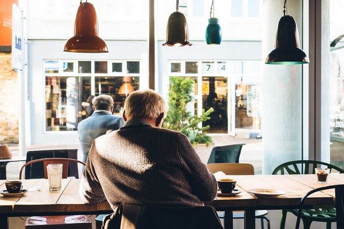 Carers Week. Old man sitting in a cafe