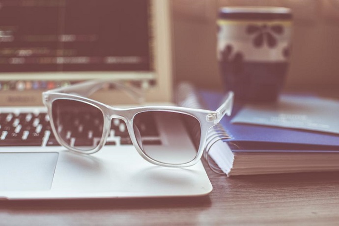 Training online. Glasses sitting on a keyboard