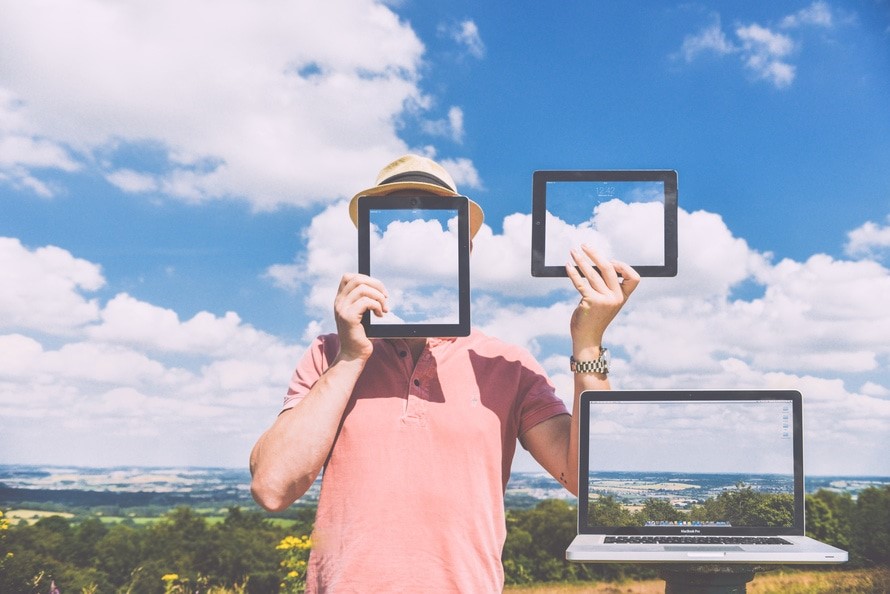 Life as a mature student. Man holding up tablet computers