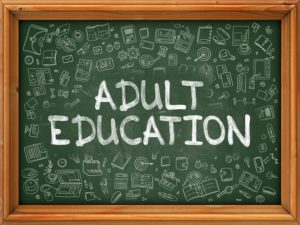 Adult Education - Hand Drawn on Green Chalkboard with Doodle Icons Around. Modern Illustration with Doodle Design Style.