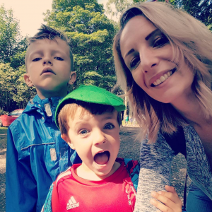 Smiling young woman and two small children