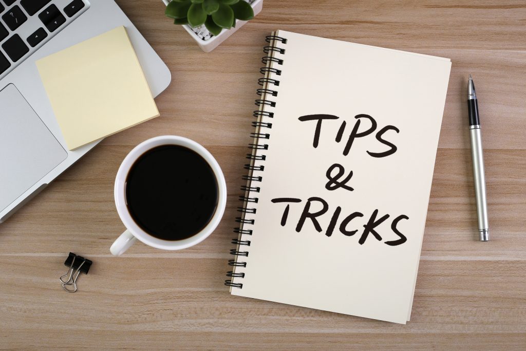 Tips And Tricks concept on desktop workspace with study supplies.