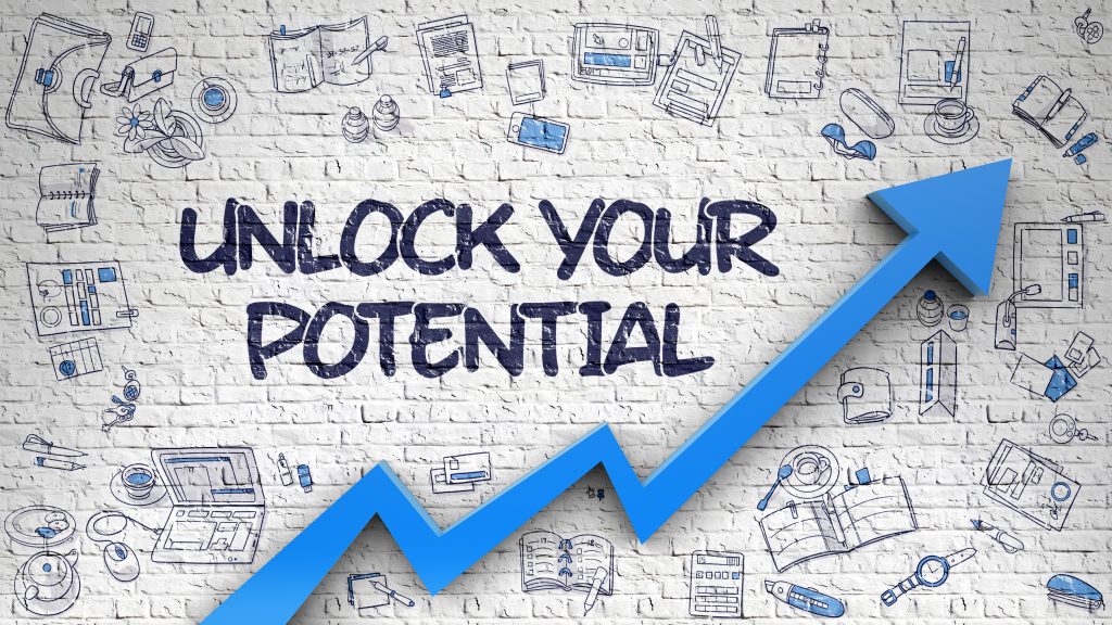 Unlock your potential written on a white wall. Words surrounded by an upwards arrow and study-related images.